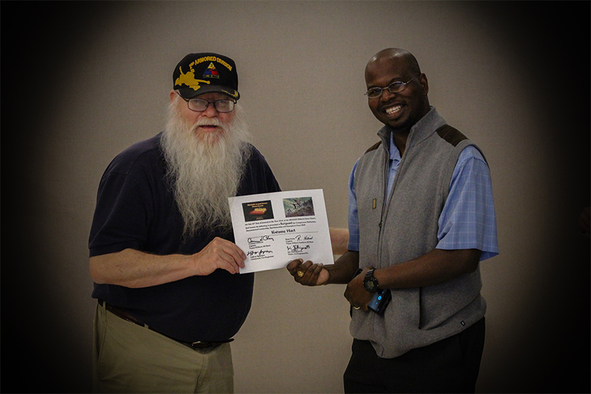 Jim Hollingsworth (left) promoting Kwame Hart (right) to Sergeant in the Texas Chess Militia.